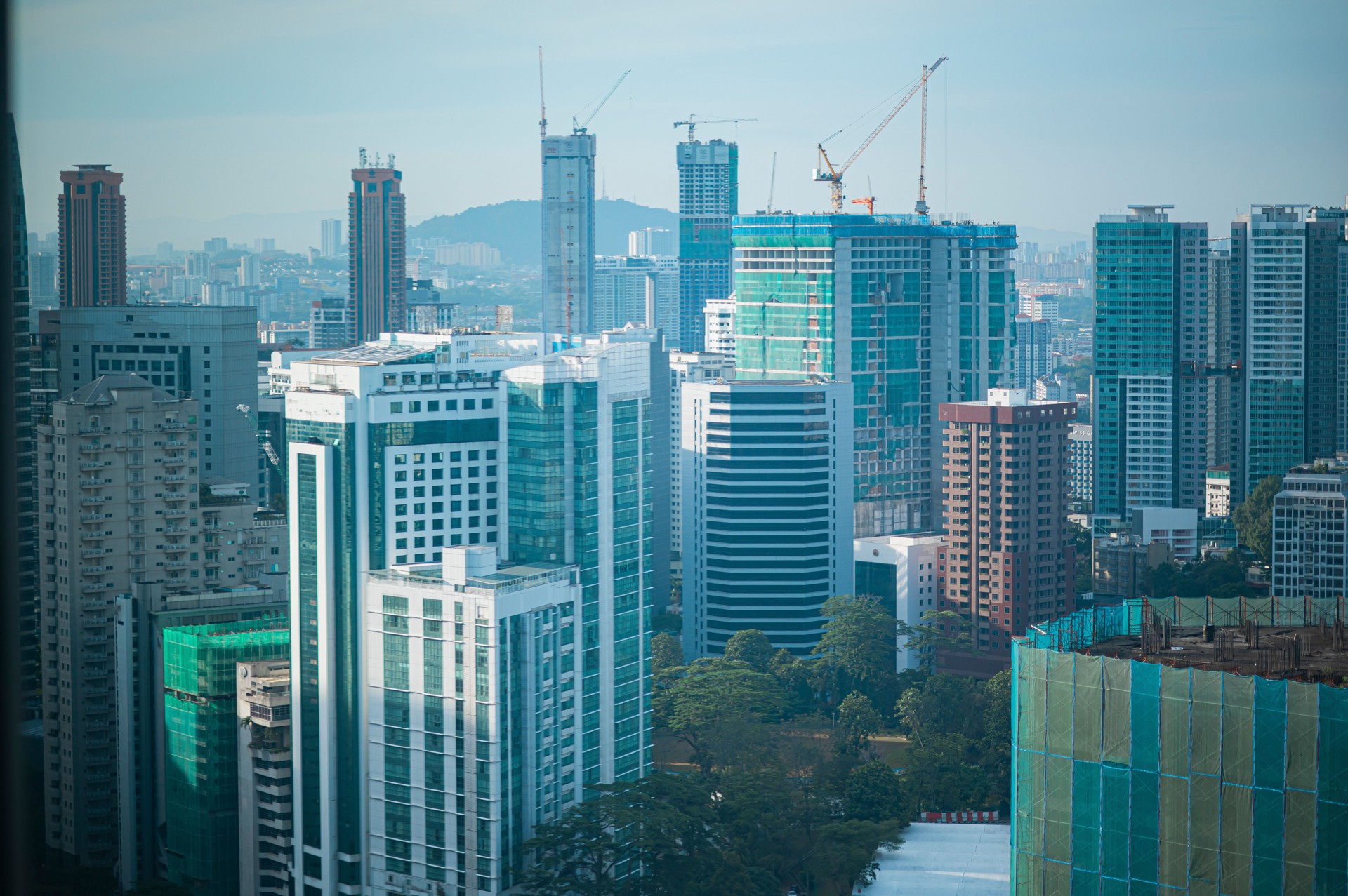 kuala lumpur skyscraper through window of high rise condominium in day time