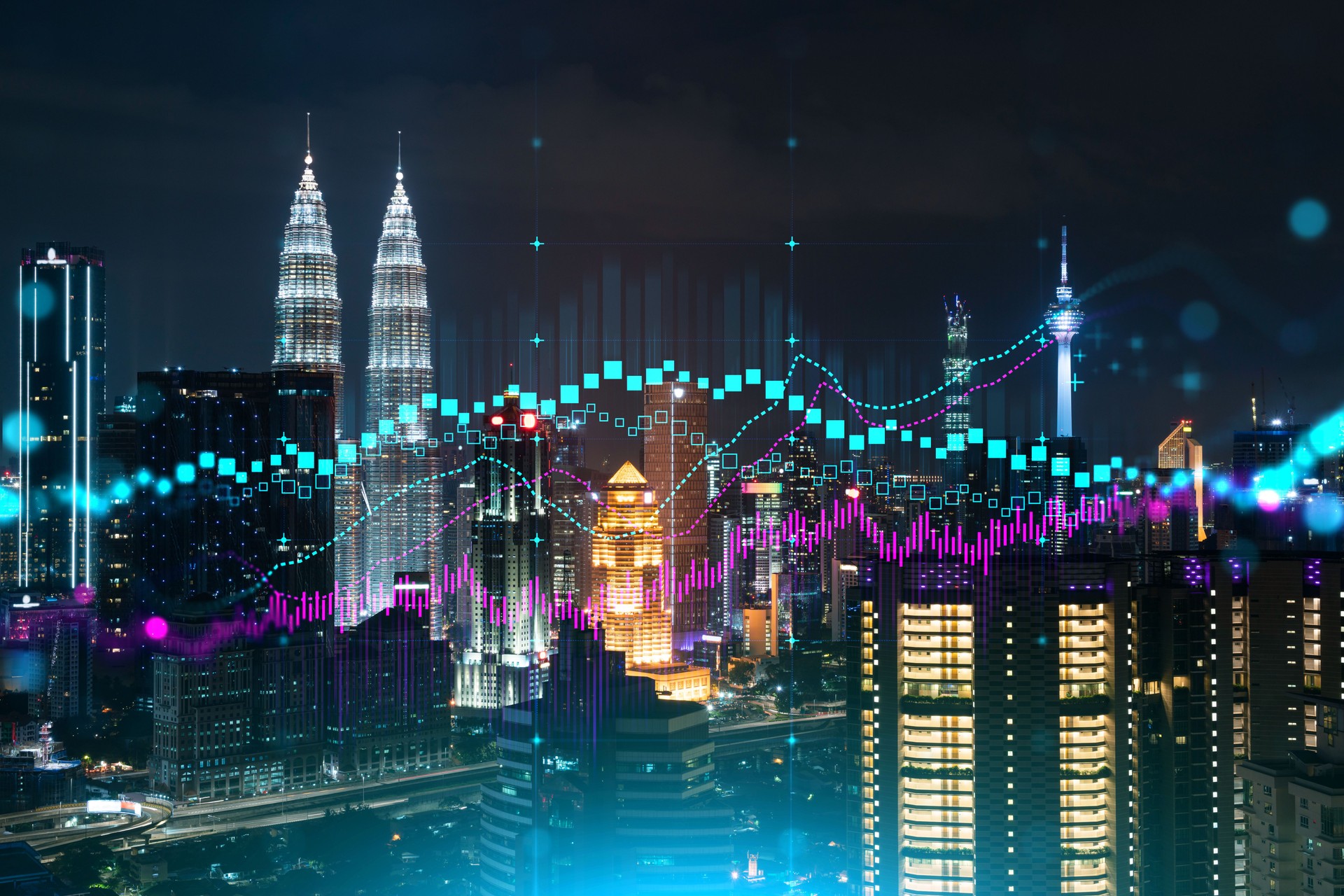 FOREX graph hologram, aerial night panoramic cityscape of Kuala Lumpur. KL is the developed location for stock market researchers in Malaysia, Asia. The concept of fundamental analysis